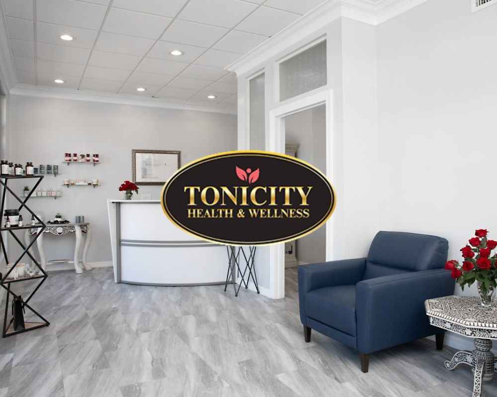 Reception area of Tonicity Health and Wellness with logo sign and seating